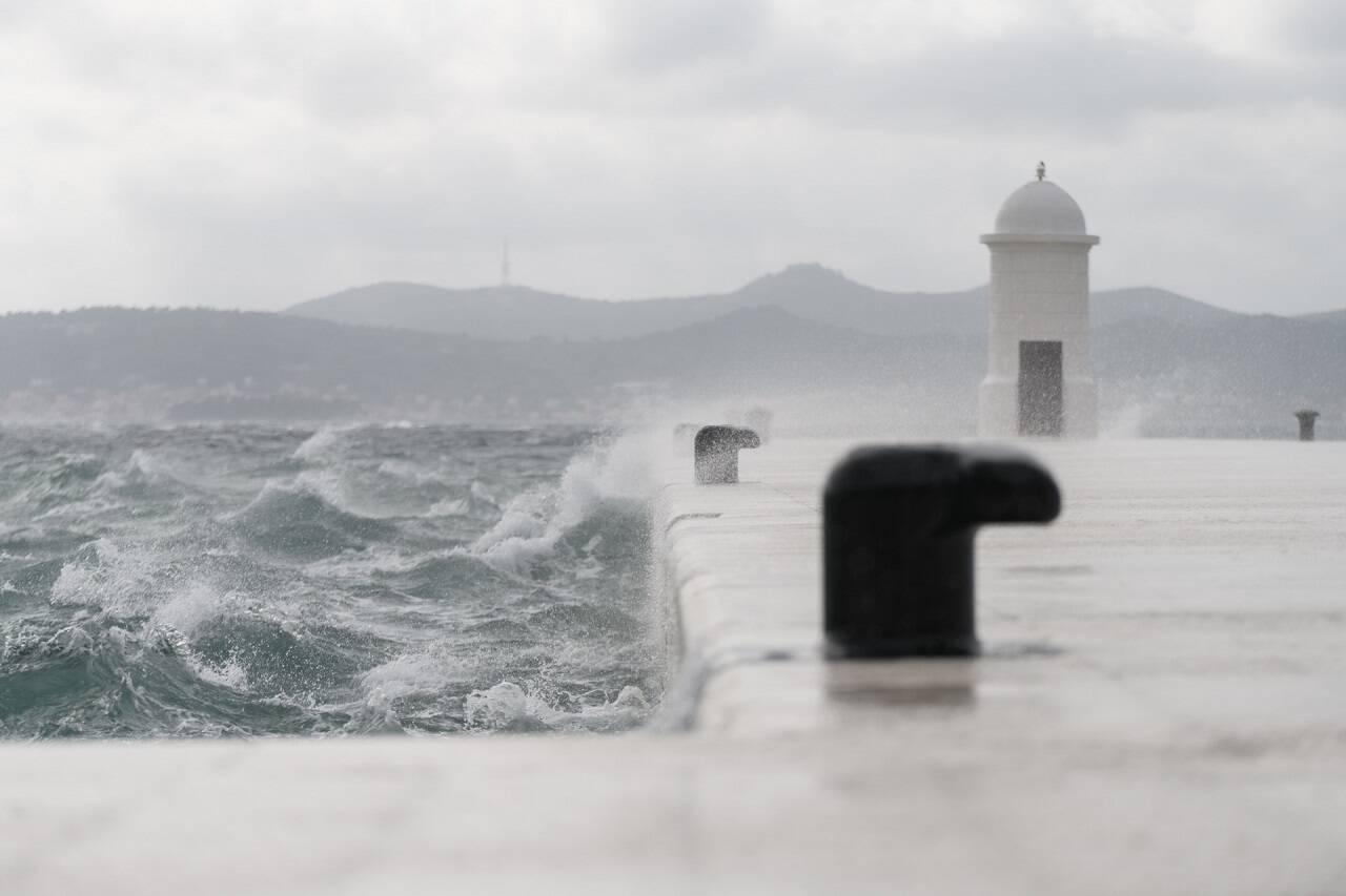 The Jugo wind whips through Zadar's Riva, transforming the waterfront into a dynamic spectacle of crashing waves and sea spray